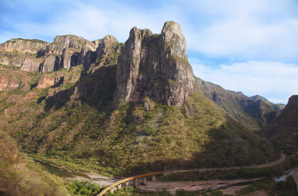View of the Copper Canyon in Mexico with the El Chepe Express Train winding through the rugged landscape.