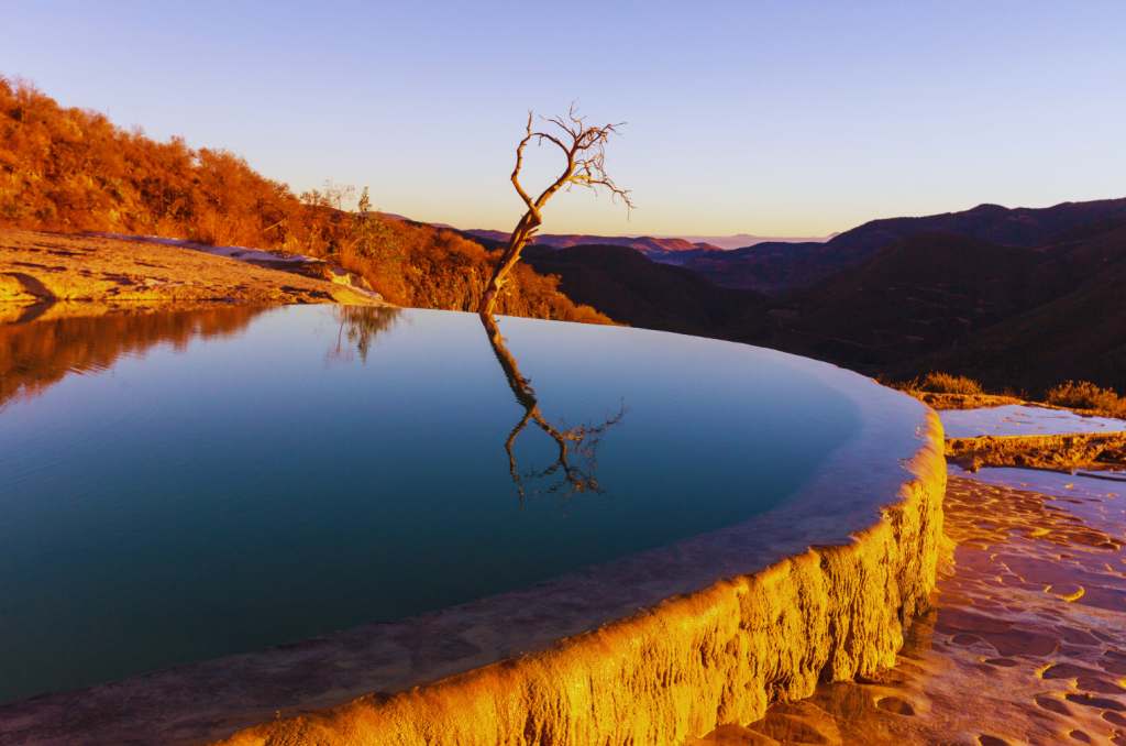 Natural pool in calcified formation in Hierve el Agua Mexico with horizon in the background.