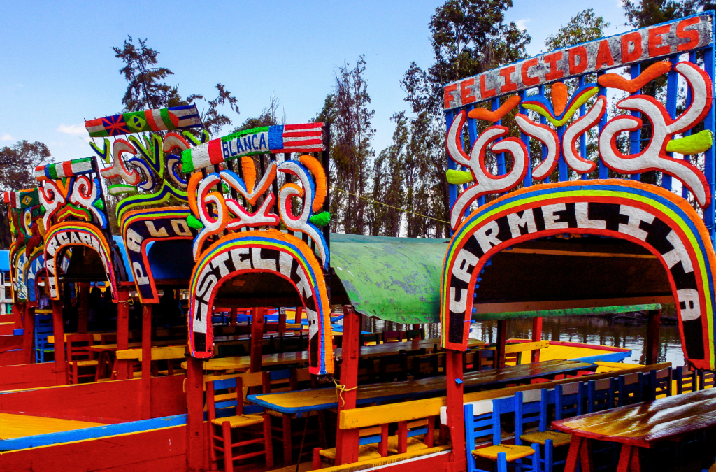 Three Colorful Boats floating in the ancient cannals of Xochimilco.